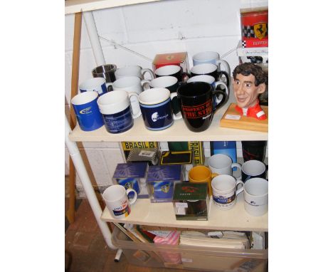 Formula 1 and football mugs, together with caricature bust of Senna - on two shelves  