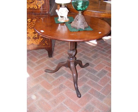 A Georgian mahogany tripod table on carved support - 76cm diameter