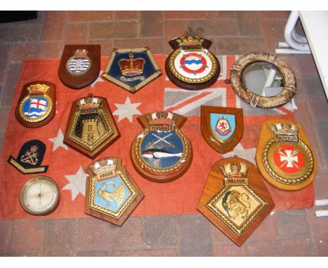 A collection of Naval and similar plaques, together with a vintage aneroid barometer and old flag, etc. 