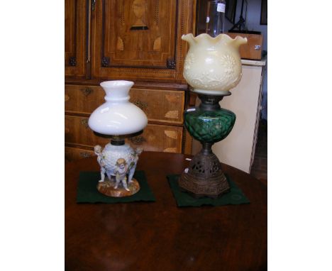 A Victorian oil lamp together with one other