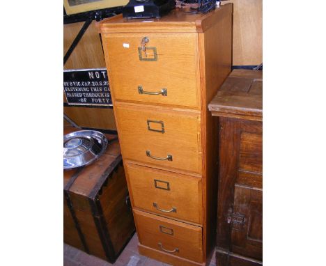 A vintage oak four drawer filing chest 