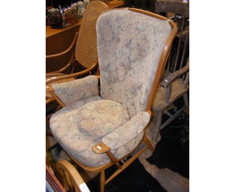 An Ercol spindle back cushioned armchair 