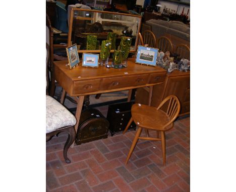 A mid century Ercol Golden Dawn dressing table, with three drawers to the apron and mirror over, together with Ercol dressing