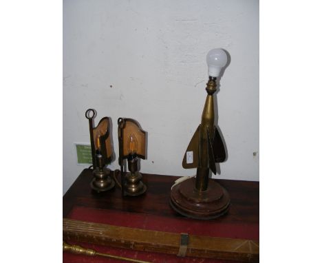 An unusual converted Ordnance round - engraved 'Lionel Corporation, New York' - converted to a table lamp, together with two 
