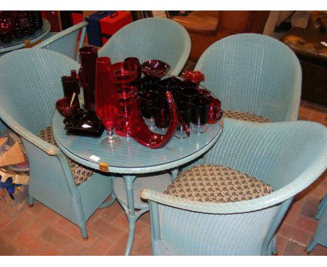 A Lloyd Loom lawn suite comprising a glass topped circular table and four tub chairs (diameter of table approx. 78cm) 