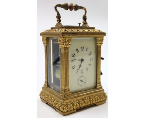 Five glass brass carriage clock with black Arabic numerals on a white face approx height not including handle 11cm