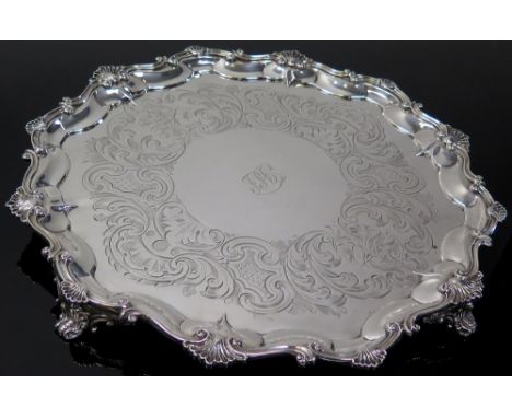 Victorian silver salver by Daniel and Charles Houle, London 1852, of circular form, with shell and scroll cast rim. Monogram 