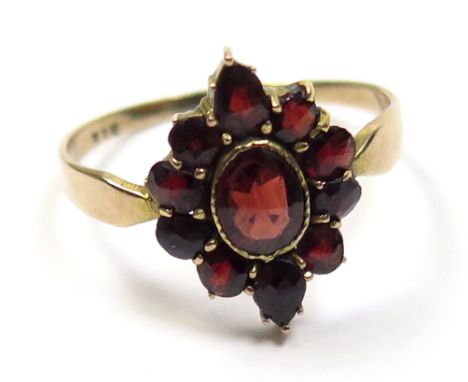 Yellow metal ring set with cluster of 11 garnets size K weight 1.3 grams