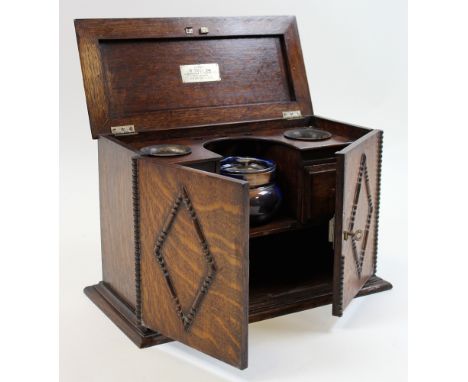 Edwardian Oak Pipe Smokers cabinet fitted with 2 drawers behind two doors and with accompanying Jar