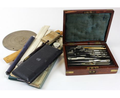 Collection of vintage Draughtsmans equipment including slide rules and a set of compasses in a fitted wooden box