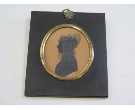 Very finely painted monochrome silhouette portrait of a lady circa 1817 mounted in an acorn topped ebonised frame