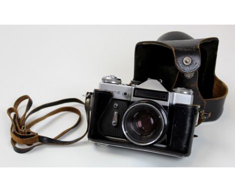 Vintage Zenit-E USSR 35mm SLR camera with Helios-44 2/58 lense fitted. Complete with leather case and strap