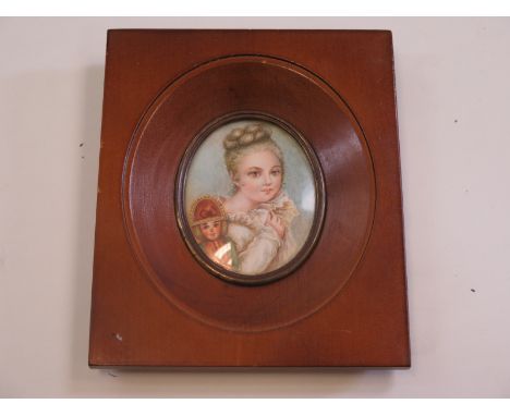 Fine 19th century French portrait miniature in oil of a lady with a catholic priest doll mounted within a brown wooden frame