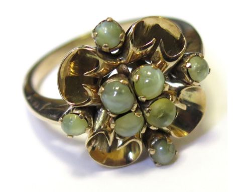 Yellow metal ring with a large gold floral setting with green onyx stones size P weight 4.4 grams