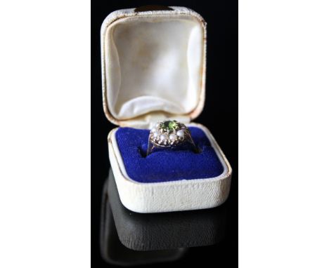 9ct Ring set with central peridot surrounded by pearls size L weight 3.4 grams