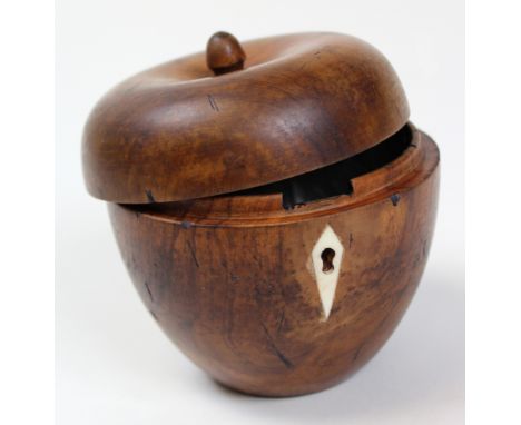 18th century apple shaped tea caddy shaped from fruitwood and lined in silver paper with an ivory escutcheon. Stands 10cm to 