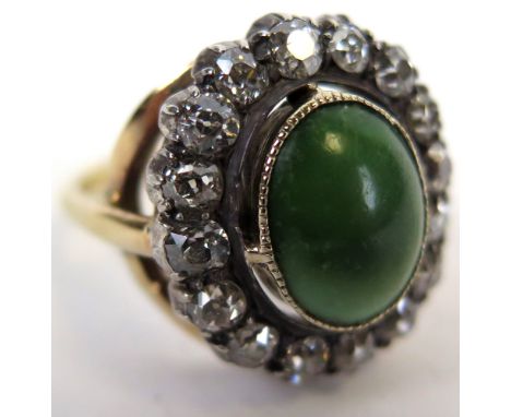 Yellow Metal Ring with a central green stone surrounded by 16 diamonds approx 1.6 carat, size R, weight 8.9 grams