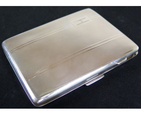 Silver Cigarette Case of hinged rectangular form, the body with engine turned decoration and "H" in the top left corner, hall