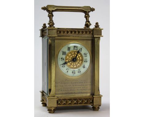 Early 20th century brass carriage clock with gilt chapter ring and archetectural styling. Inscription to the front To Dr Albe