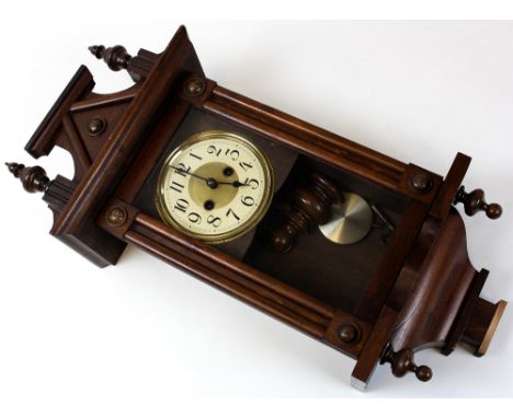 American wall clock of architectural form with pendulum and key included. 