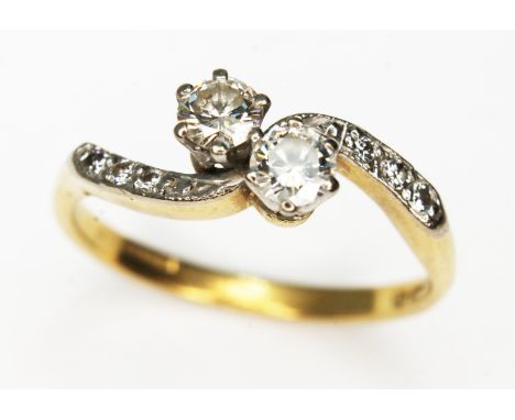 A diamond cross over ring, the two round brilliant cut diamonds weighing approx. 0.19 &amp; 0.23 carats, colour K/L, clarity 