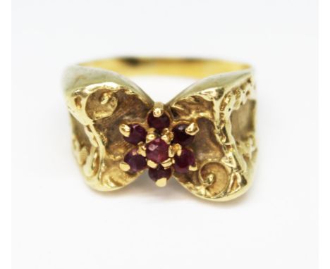A ruby cluster ring, band unmarked, probably 9ct, gross wt. 6.8g, size K. 