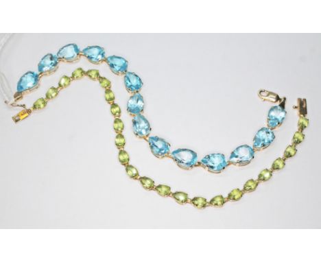 Two bracelets marked '10K', one set with blue topaz and the other peridot, lengths 18cm, gross wt. 16.4g. Condition - good, b