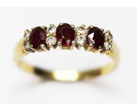 A hallmarked 18ct gold diamond and ruby cluster ring, gross wt. 2.8g, size O.&nbsp;Condition - slight abrasions/nibbles to fa