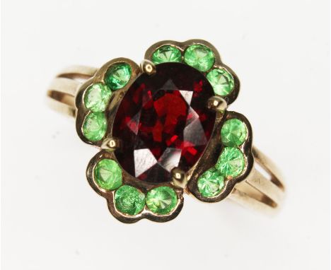 A hallmarked 9ct gold red garnet and tsavorite cluster ring, gross wt. 3.8g, size R.  
