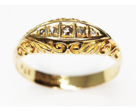 An Edwardian 18ct gold diamond ring, five rose cut diamonds, scroll setting, Birmingham 1910, gross wt. 2.8g, size R/S.  