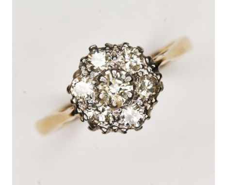 A seven stone diamond cluster ring, total approx. diamond wt. 0.21 carats, colour K/L, clarity VS1/SI1, the cluster measuring