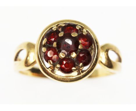 A garnet cluster ring, marked '750', gross wt. 2.7g, size K.  