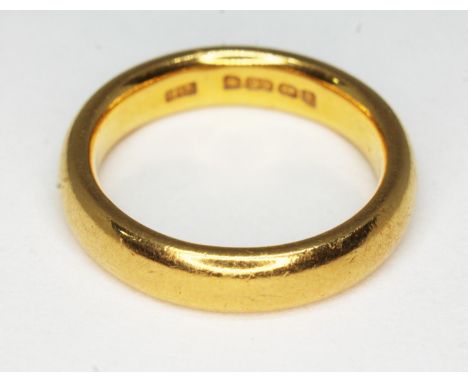 A hallmarked 22ct gold wedding band, wt. 7.4g, size K/L.  