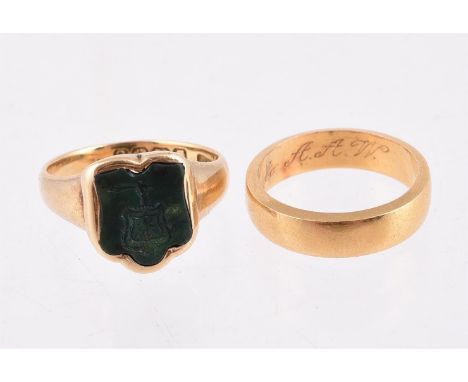 
	
		A CARVED BLOODSTONE SIGNET RING 
		BIRMINGHAM 1904
		The shaped bloodstone panel carved with a crest; together with a po