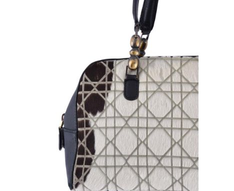 
	
		CHRISTIAN DIOR, CANNAGE MARIS PEARL 
		A BLACK LEATHER AND FAUX FUR BAG
		With twin leather loop handles, the zip fasten