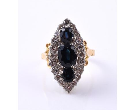 
	
		A SAPPHIRE AND DIAMOND MARQUISE CLUSTER RING
		The marquise shaped panel with a trip of oval cut sapphires within a bord