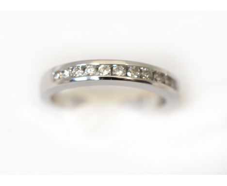 An 18ct white gold H/M diamond set half eternity ring, estimated total diamond weight .025cts, approx colour H/I &amp; clarit