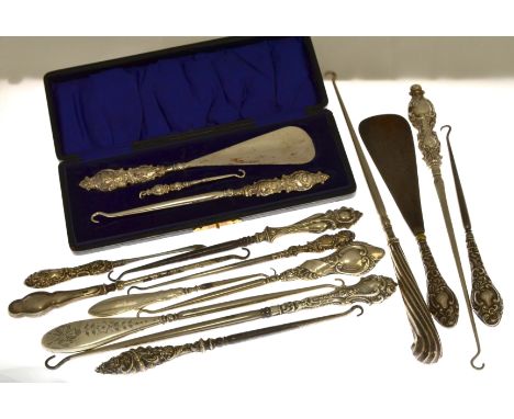 A cased set of button hooks &amp; shoe horn H/M Birmingham 1912 together with thirteen assorted silver mounted button hooks &