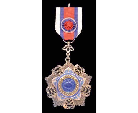 *China, Order of the Brilliant Jade, Sixth Class breast badge, in silver-gilt, silver and blue enamel with blue jade centre, 