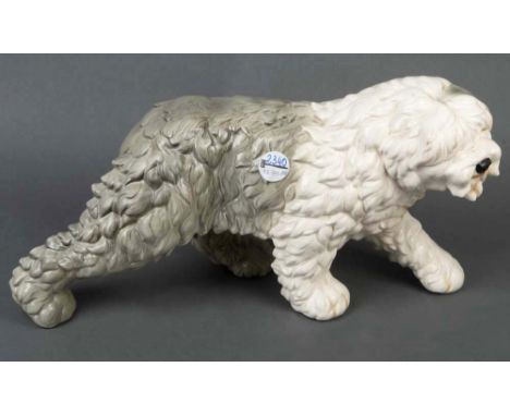   Schreitender ungarischer Hirtenhund. Goebel 20. Jh. Feinsteinzeug, bunt bemalt, H=24,5 cm, B=47,5 cm, T=20 cm.           