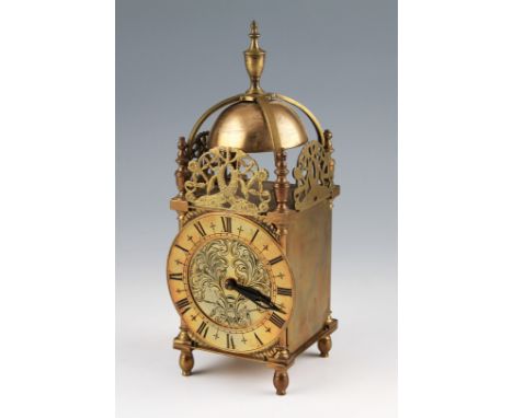 A 20th Century brass lantern lamp with French movement, the brass chapter ring having black Roman numeral hourly markers with