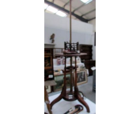 An adjustable mahogany standard lamp