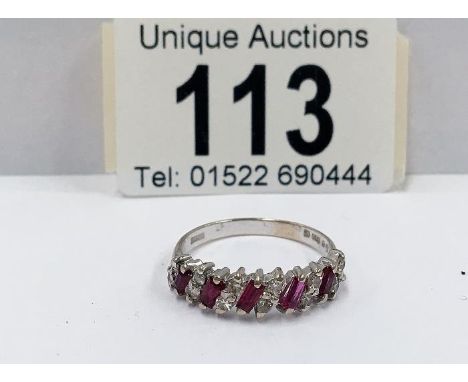 A 14ct yellow gold ruby and diamond ring (baguettes and brilliants)