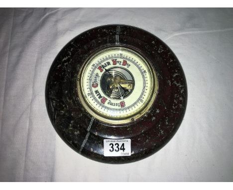 A super red Cornish Serpentine barometer with porcelain face, 23cm diameter
