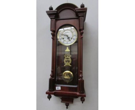 A modern mahogany wall clock