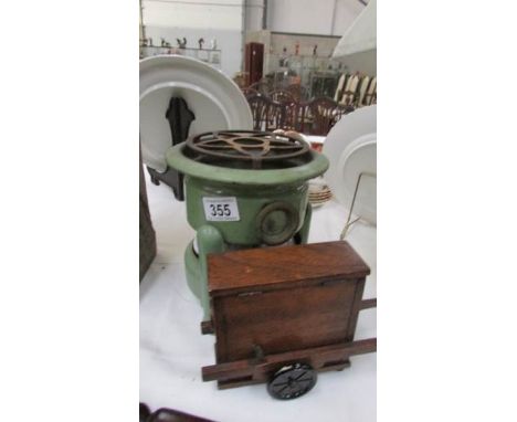 A green enamel stove and a musical box in the form of a street piano