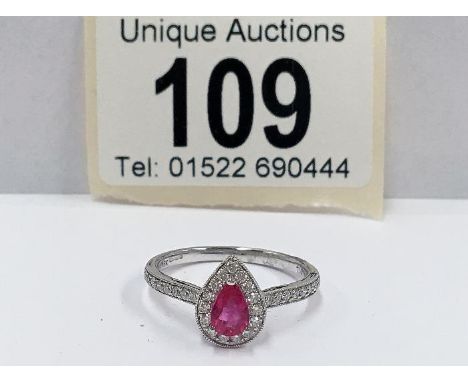 An 18ct white gold pear shaped ruby and diamond ring