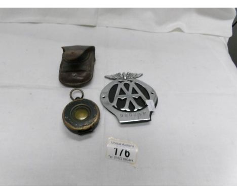 An AA badge and a leather cased compass
