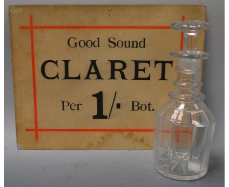 A George III glass decanter, mushroom stopper;  an Edwardian Good Sound Claret advertising card (2)