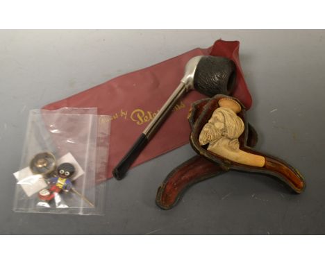 A Ronson pipe; a Robinson's Golly enamel badge; a momento mori pin; a meerschaum pipe (5)